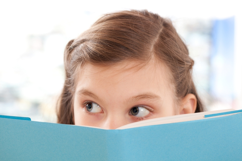 Girl Reading A Book At School